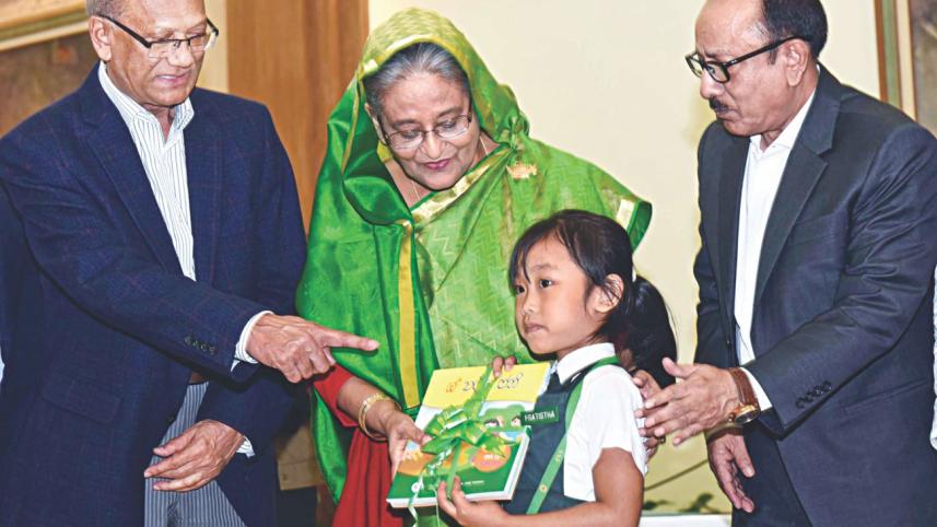 Hasina handing free textbooks.jpg