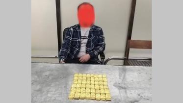 Customs officials detain a Chinese national on charge of smuggling in 48 gold bars at Dhaka airport