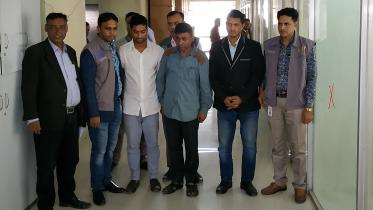 Law enforcers pose with an impersonating customs officer and his two assistants