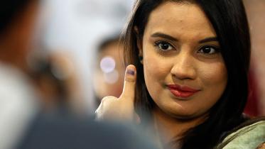A woman flashes the ink on her thumb