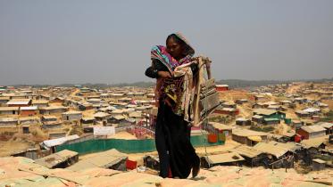 A Rohingya refugee woman walks along the Kutupalong refugee camp
